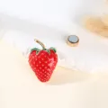 Detailed close up view of the enamel strawberry brooch showing gold tone stem and textured finish. - Strawberry Style / 5