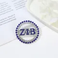 Close-up view of a circular rhinestone brooch with blue enamel Greek letters detail. - Style 8 ZΦB Blue White Rhinestone Round Style