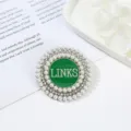 Round alloy brooch featuring layered pearls, rhinestones, and a green enamel LINKS center. - Style 2 LINKS Letter Layered Pearl Green Disk Style