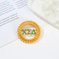 Close-up detail of a gold double-layer pearl round brooch pin with green Greek letters. - Style 6 XΣΔ Green Enamel Letter Round Style