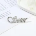 Pearl letter brooch detail shot, showing exquisite alloy texture and delicate faux pearls. - Style 10 Artificial Pearl Cursive Letter Shape