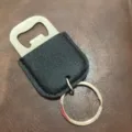 Stainless steel bottle opener with PU leather key ring detail view for beer and cocktail tools. - Black