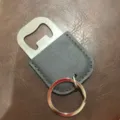 Stainless steel bottle opener with grey PU leather sleeve and metal key ring keychain. - Light Gray