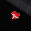 Detail shot of a red heart shaped ecg enamel pin, creative medical style lapel badge jewelry. - Heartbeat ECG Pattern Pin