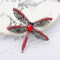 Detailed close-up of sparkling rhinestone dragonfly brooch with red crystals and silver wings. - Silver Red Rhinestone Large Main Stone Dragonfly Style (0401-03)