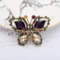 Close-up detail of vintage butterfly brooch with purple and champagne crystals on metal wings. - Antique Gold Vintage Amethyst Butterfly Style (0401-03)