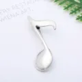 Close-up of a vintage silver musical note metal brooch detail shot elegance accessory - Silver Musical Note Style (0401-4)