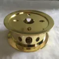 Golden metal tea warmer detail showcasing the hollow round ventilation holes and polished finish. - EK2127G
