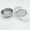Stainless steel tea strainer with delicate hollow lace handles and matching bowl for loose leaf tea. - Lace Tea Strainer (With Round Bowl Base) / Silver
