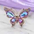 Elegant crystal butterfly brooch detail, vintage luxury gold-tone metal lapel pin accessory. - Colorful Purple