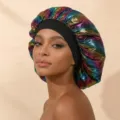 Close-up detail showing the metallic rainbow satin texture and black elastic band of the sleep cap. - One Size / Black