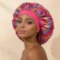 Detail view of large metallic laser satin sleep cap, smooth hair care bonnet for women. - One Size / Rose Red