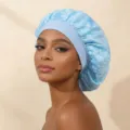 Detailed view of the light blue satin double layer sleep cap with delicate floral embroidery and elastic. - One Size / Light Blue