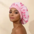 Pink floral satin sleep cap with wide elastic band for comfortable women hair protection. - One Size / Pink