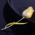 Closeup shot of exquisite tulip brooch detail, metal flower design with rich texture and shine. - Yellow Series