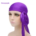 Detail view of the deep purple silky durag, showing the soft satin fabric and long tail. - One Size / Deep purple