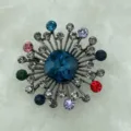 Detailed close-up view of geometric alloy crystal brooch showcasing vibrant colorful stones. - Style 3