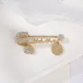 Gold tone rhinestone safety pin brooch with hamsa hand and coin pendant fashion jewelry - All White