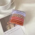 Colorful braided hair ties set in a clear box, elegant styling for women and girls. - 8-Piece Set / Orange Tones