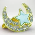 Gold crescent moon and star brooch detail showing sparkling rhinestones and blue enamel. - Style 5 Blue Star Moon