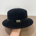 Detailed view of the black knitted bucket hat showing the leather strap and metal buckle accent. - M (56-58cm) / Black