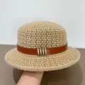 Detailed view of a woven flat-top bucket hat with brown leather belt and gold metal buckles. - M (56-58cm) / Light Khaki