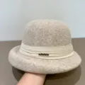 Detail view of a stylish women's wool felt dome hat in light camel with ribbon & metal decor. - M (56-58cm) / Beige