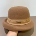 Close-up detail of a brown wool felt bowler hat featuring a ribbon and rhinestone metal badge. - M (56-58cm) / Khaki