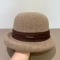 Detail view of the elegant wool felt dome hat featuring a brown ribbon and metal decor. - M (56-58cm) / Mocha
