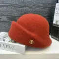 Faux wool retro bucket hat detail, elegant orange winter warm painter hat with gold metal logo. - Caramel color