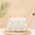 Detail shot of elegant white evening handbag featuring 3D fabric roses, pearl handle and chain. - Off White