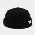 Zwarte, versleten gebreide docker muts met een stijlvol geweven label aan de zijkant - Eén maat / Zwart