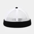 Close-up view of the breathable mesh texture and black rolled brim of this casual docker cap. - Adjustable / White