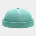 Close-up of the washed gradient denim docker cap showing fine stitching and texture. - Teal