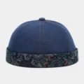Detail shot of a retro washed denim docker cap with a stylish paisley brim and orange stitches. - Adjustable / Blue
