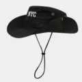 Close-up details of the black bucket hat showcasing white NYC embroidery and chin strap. - Black