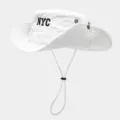 Close-up detail of white sun hat featuring NYC embroidery and adjustable chin drawstring. - White