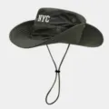 Detail view of the green outdoor bucket hat featuring white NYC embroidery, adjustable wind cord. - Army Green