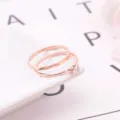 Detailed close-up shot of a chic rose gold two-piece ring set featuring a sparkling zircon. - Size 6 / Rose Gold