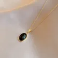 Elegant gold-tone chain necklace featuring a chic black oval gemstone pendant for daily wear. - Black Cat's Eye Stone / Gold