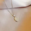Elegant stainless steel oval pendant necklace with minimalist design for daily wear. - White Cat's Eye Stone / Silver