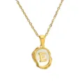 Detailed close-up of gold stainless steel letter E pendant necklace featuring mother of pearl. - Letter E