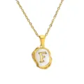 Detail view of the gold stainless steel letter F necklace with mother-of-pearl pendant. - Letter F