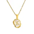 Detailed close-up view of the elegant gold necklace featuring an irregular shell letter K pendant. - Letter K