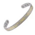 Detailed view of the open magnetic bangle bracelet featuring a two-tone floral vine relief. - 6 Magnets Silver with Gold Plating