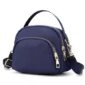 Mini nylon shell crossbody bag detail view, lightweight daily shoulder purse with gold zippers. - Blue