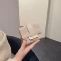 Beige tweed trifold wallet with vertical leather strap, compact and stylish daily accessory. - Khaki