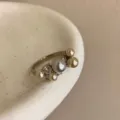 Elegant pearl ring with mixed size pearls, a grey center pearl and sparkling stones in chic style. - Style R-1202-B Ring (R-1202-B)