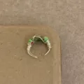 Detailed closeup view of handmade wire wrapped ring featuring colorful beads and wire. - R-784-C Green Stone Red White Patterned Beads Style
