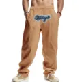 Casual men's linen wide-leg pants detail, featuring front graphic print and drawstring. - Earthy Yellow